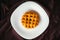 Homemade pineapple cake on a white plate with black background, gourmet bakery