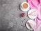 Homemade pink cheesecake with cup of coffee on a gray concrete background. top view, copy space