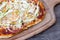 Homemade pizza detail on wooden background