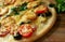 Homemade pizza with pepperoni, tomatoes, mozzarella and Basil, edible, on a wooden table