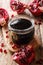 Homemade pomegranate sauce narsharab in a glass jar close-up. vertical