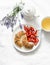 Homemade poppy seeds croissants, strawberries, green tea, a bunch of lavender on a light background, top view