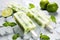 Homemade popsicles with lime and mint on white table, closeup, Lime ice cream popsicles with lime and mint on white stone