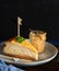 Homemade portion Basque burnt creamy cheesecake, New York style Cheesecake with Dulce de leche or manjar, dark background,