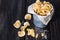 Homemade potato chips over dark wooden background