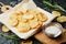 Homemade potato chips with sea salt and herb on cutting board