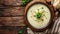 Homemade potato soup with onion on table