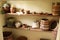 Homemade pots jugs tubs and food supplies in a store room of a village house