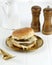 Homemade Premium Cheese Hamburger on Golden Plate, White Table