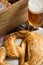 Homemade Pretzel with Sea Salt and Glass of Beer on Rustic Wooden Table