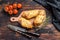 Homemade Pretzel Wrapped Hot Dog, sausage in the dough. Dark wooden background. Top view