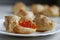 Homemade profiteroles with red caviar with on light background. Sea food