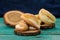 Homemade puff cookies on wooden stands on turquoise table