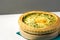 Homemade puff pastry quiche lorraine with leeks swiss gruyere and soft goat cheese with scrumptious golden crust on serving board