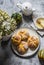 Homemade pumpkin buns, teapot, honey - cozy still life on a gray background, top view