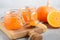 Homemade pumpkin and orange confiture in a jars on a gray concrete background.