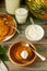 Homemade pumpkin pancakes with sour cream, ripe pumpkin and pumpkin leaves.