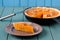 Homemade pumpkin pie with wallnuts on turquoise wooden table