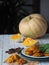 Homemade pumpkin shortbread cookies with raisins on the background of pumpkin fruit. Healthy diet food. Side view