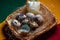 Homemade quail eggs close up view with hen candle. Easter. Protein and Healthy diet. Fresh organic quail eggs in wicker basket. Di