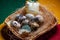 Homemade quail eggs close up view with hen candle. Easter. Protein and Healthy diet. Fresh organic quail eggs in wicker basket. Di