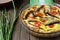 Homemade quiche with vegetables and fish, sprats