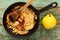 Homemade quince crumble pie in cast iron pan and whole yellow quince