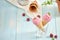 Homemade raspberry ice cream in waffle cones on rustic wooden background, selective focus. Summer time