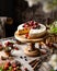 Homemade raspberry sliced biscuit cake with white cream and berries on top on wooden cake stand