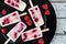 Homemade raspberry vanilla ice pops on a black plate