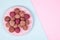 Homemade Raw Energy Balls on Vintage Plate on Blue and Pink Paper Background