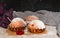 Homemade red currant muffins with sesame seeds. Falling icing sugar over fresh baked muffins. Closeup