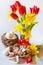 Homemade regional gingerbread cakes in the wicker nest with tulip and daffodils flowers