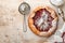 Homemade rhubarb galette made with star pattern on old concrete table background. Process of baking. Open pie. Christmas and New