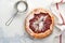 Homemade rhubarb galette made with star pattern on old concrete table background. Process of baking. Open pie. Christmas and New