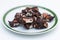 Homemade Rocky road chocolate on white plate with green trim on