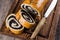 Homemade roll with poppy seeds on wooden board on wooden table background. Close up