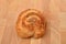 Homemade roll of puff pastry with nuts on wooden background. Sweet pastry. Selective focus