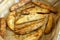 Homemade Rosemary Potato Wedges on a baking tray, low angle view. Close-up