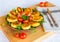 Homemade ruddy cheese and potato cutlets, decorated with fresh tomatoes and parsley, in ceramic plate on wooden board