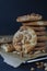 Homemade ruddy cookies with nuts lie pyramid on baking paper on a dark background