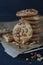 Homemade ruddy cookies with nuts lie pyramid on baking paper on a dark background