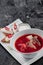 Homemade Russian, Ukrainian and Polish national soup - red borscht made of beetroot, vegetables and meat with sour cream