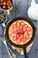 Homemade rustic strawberry pie in cast iron skillet decorated wi