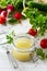 Homemade salad dressing vinaigrette with mustard, olive oil, lemon juice and various fresh vegetables and herbs