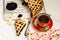 Homemade sand cake with cherry jam on a lattice and a cup of tea