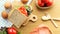 Homemade sandwich breakfast preparing. Whole wheat bread stacked on a wooden cutting board. Slice tomatoes and lettuce placed on a