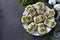 Homemade sandwiches with kiwi, herring, cream cheese and garlic on dark gray background. Space for text