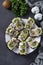 Homemade sandwiches with kiwi, herring, cream cheese and garlic on dark gray background. Vertical format. Top view