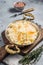 Homemade sauerkraut with black pepper and salt in a skillet. Gray background. Top view